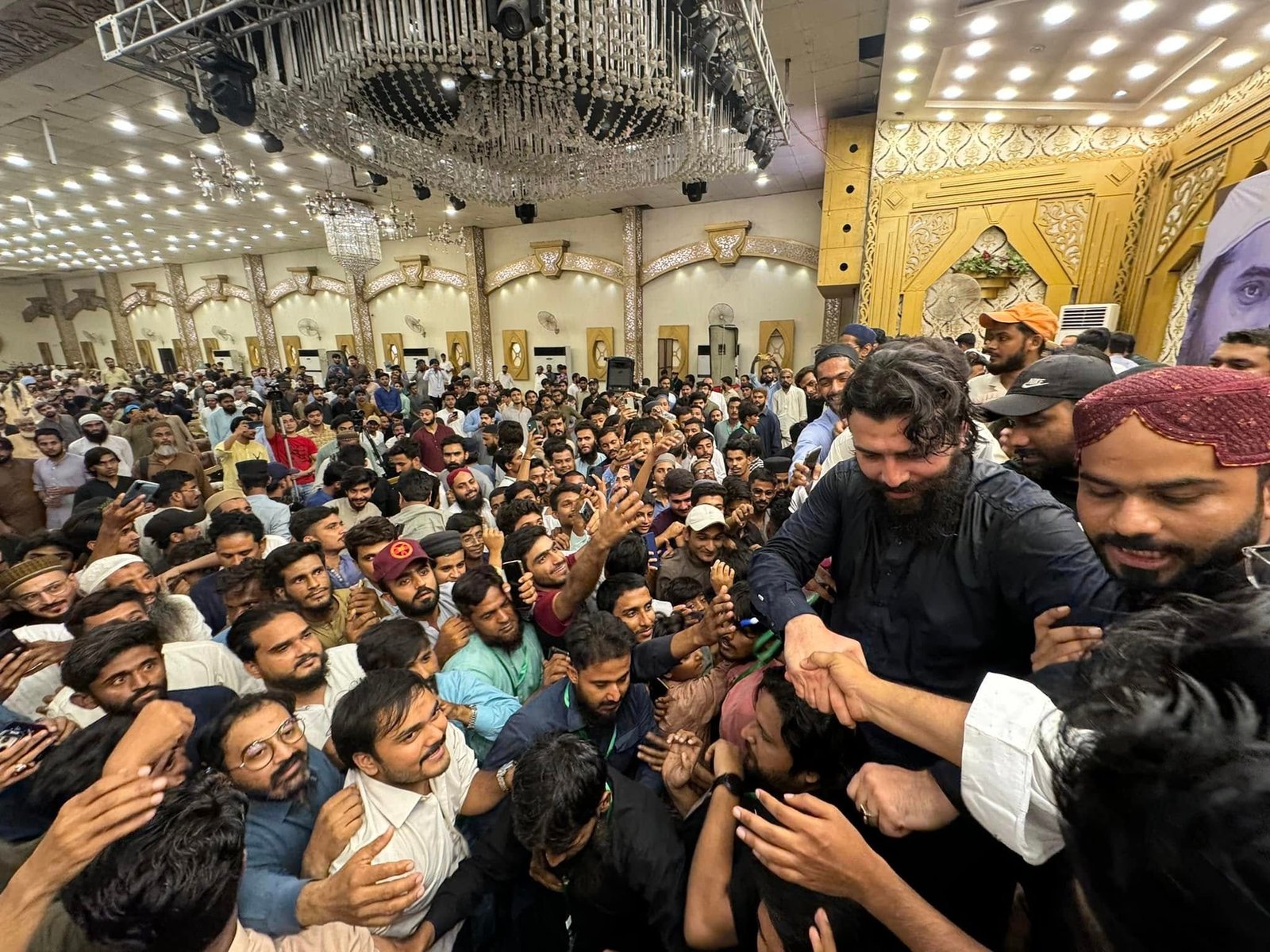 Guest speaker surrounded by enthusiastic crowd at Hyderabad event