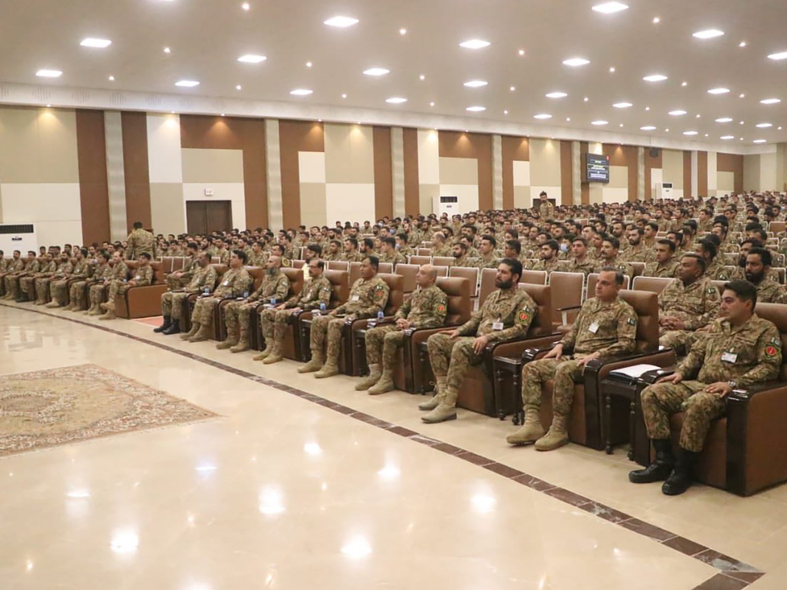 Indoor audience seated attentively at the Spirit of Jihad event