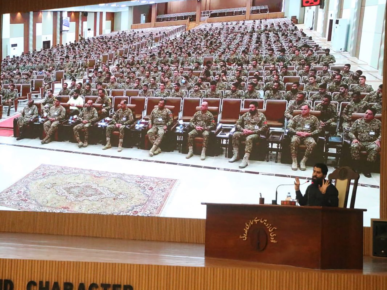 Wide view of outdoor military seating setup during the ceremony