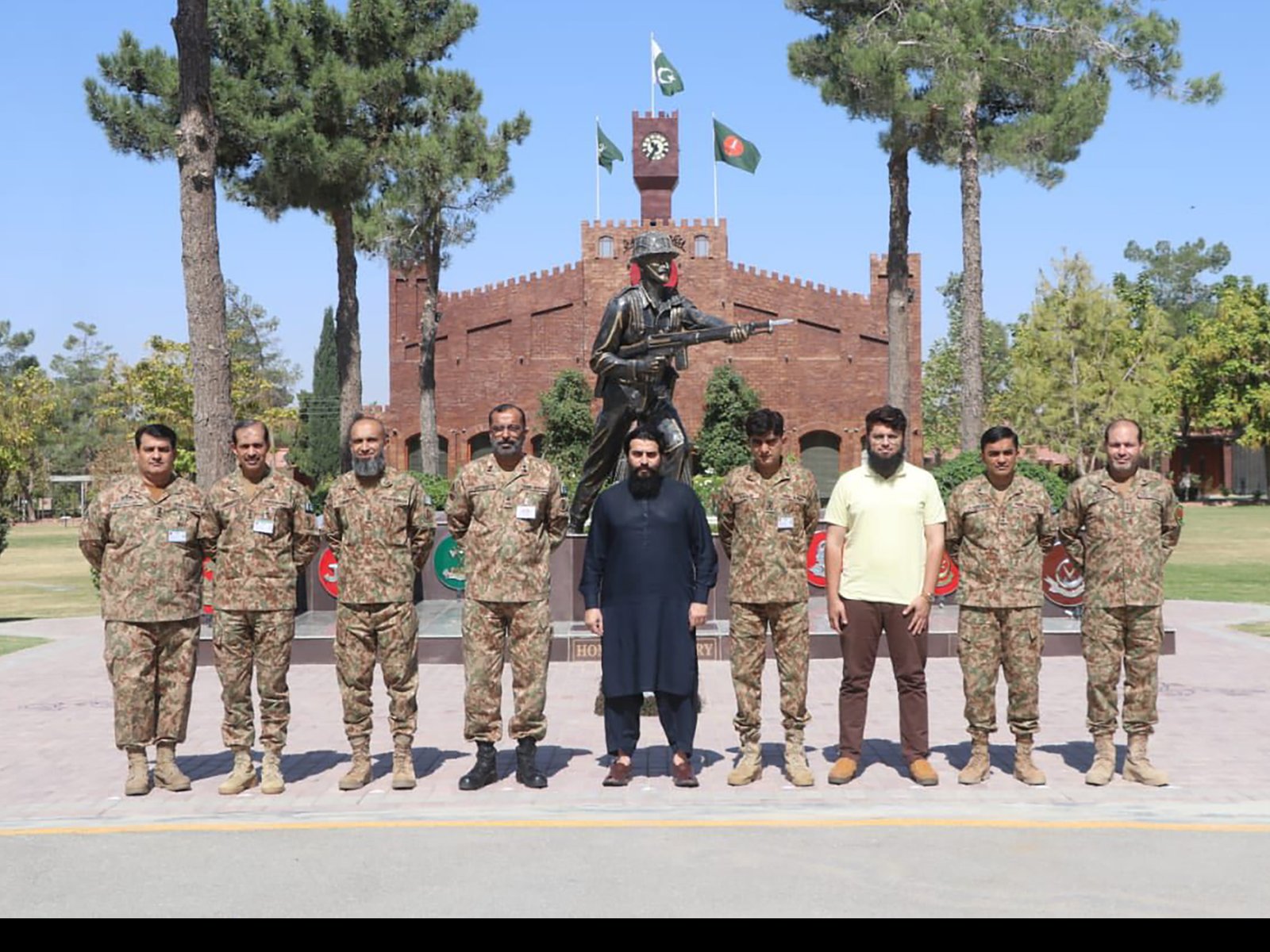 Cadets standing in formation holding national flags at the opening ceremony