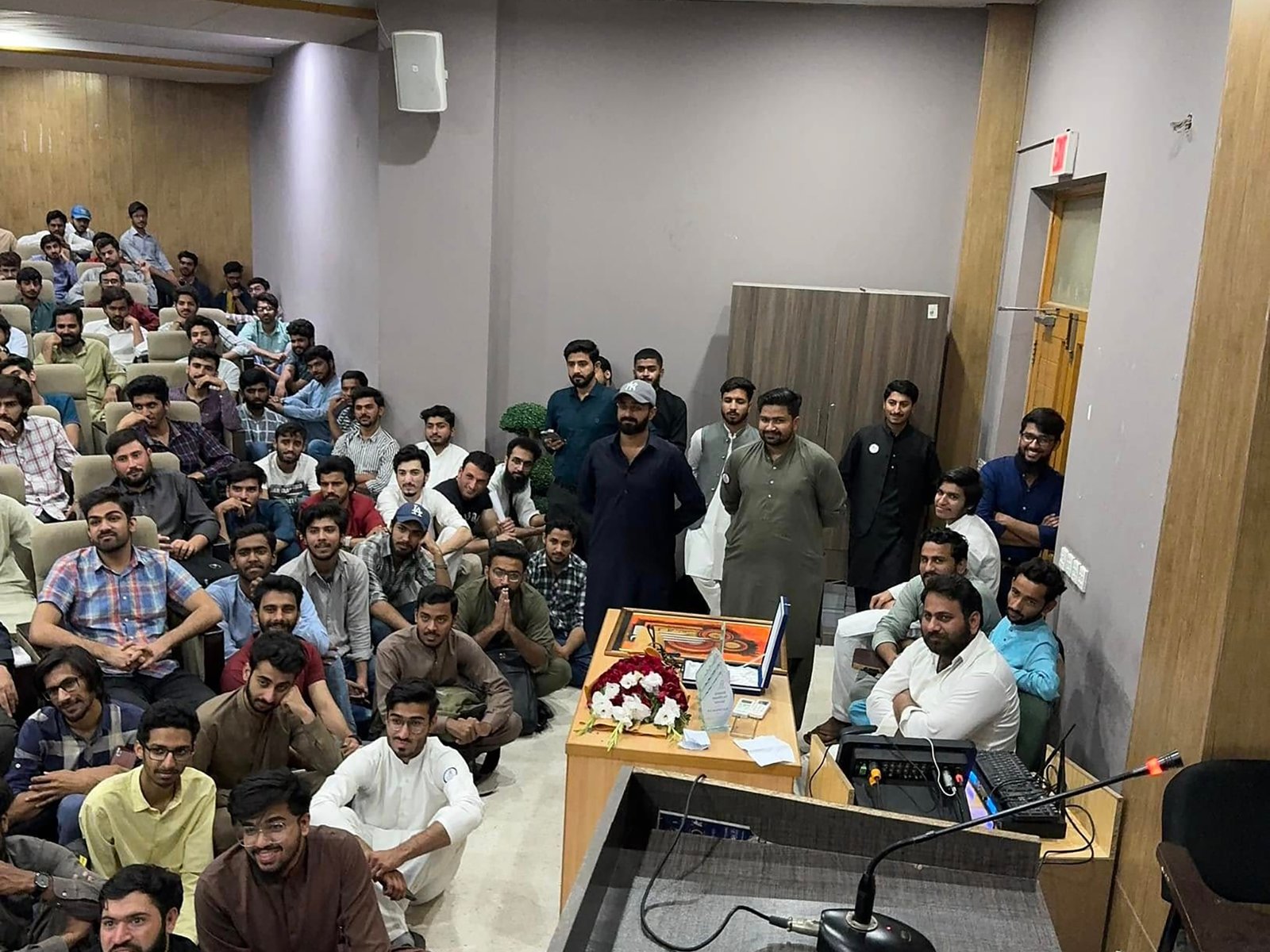 Backstage cake-cutting moment with guest speaker and organizing team at UOL