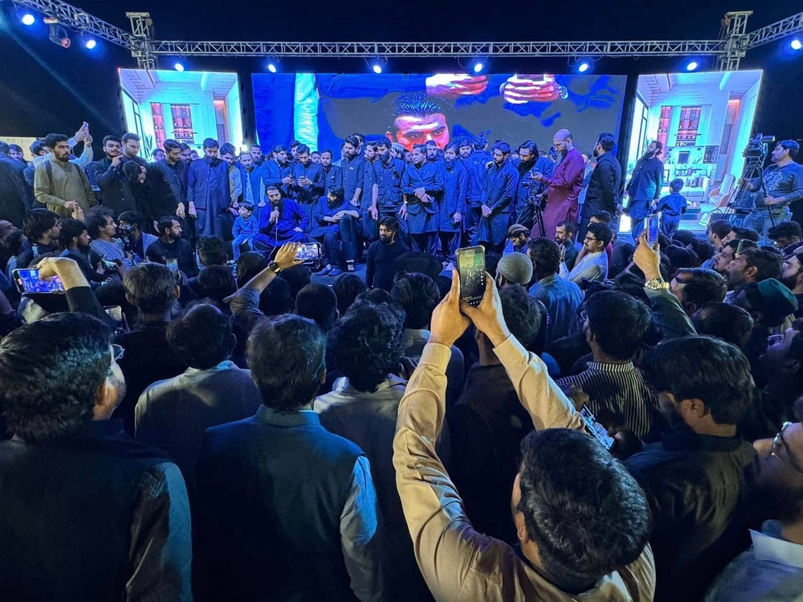 Wide shot showing the stage and audience during the Milestone Ceremony at Pearl One Courtyard