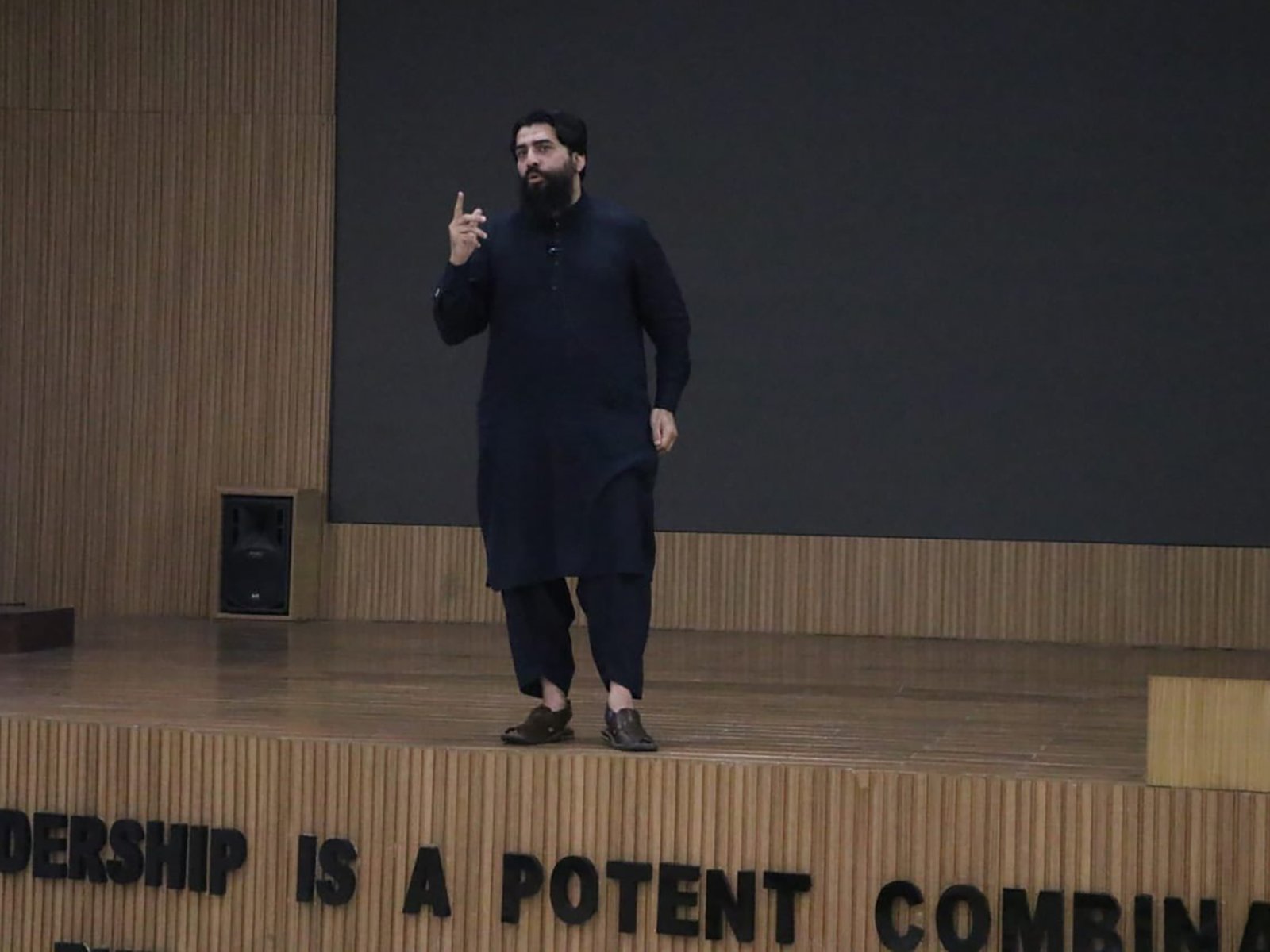 Speaker addressing audience from podium at Quetta military event