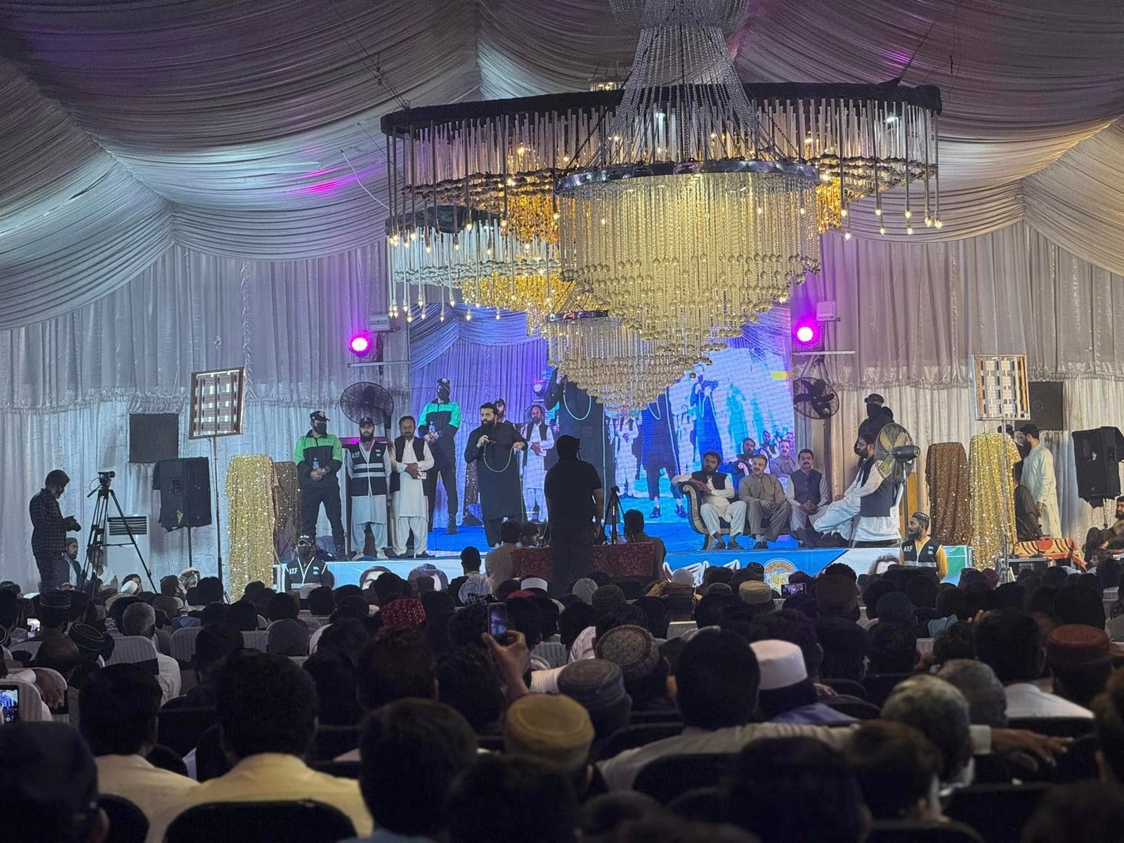 Colorful lighting and audience view from side angle during stage session