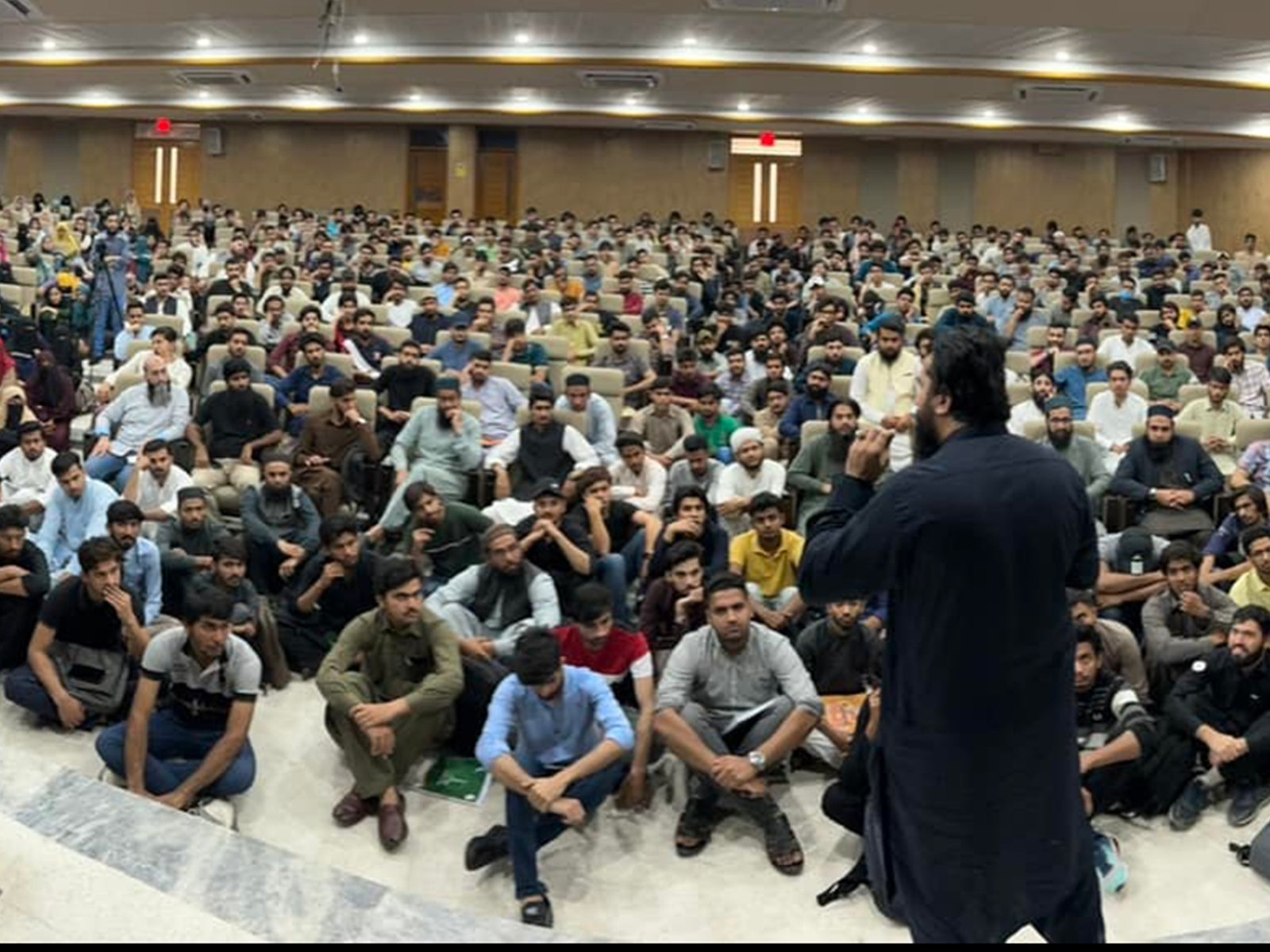 Seated attendees engaged during the historic youth session in Lahore