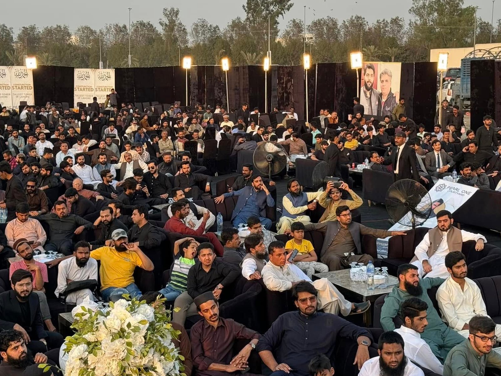 Audience seated in the open-air area of Pearl One Courtyard during the ceremony